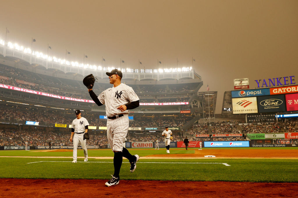 General view of hazy conditions as Anthony Rizzo of the New York Yankees jogs to the dugout at Yankee Stadium