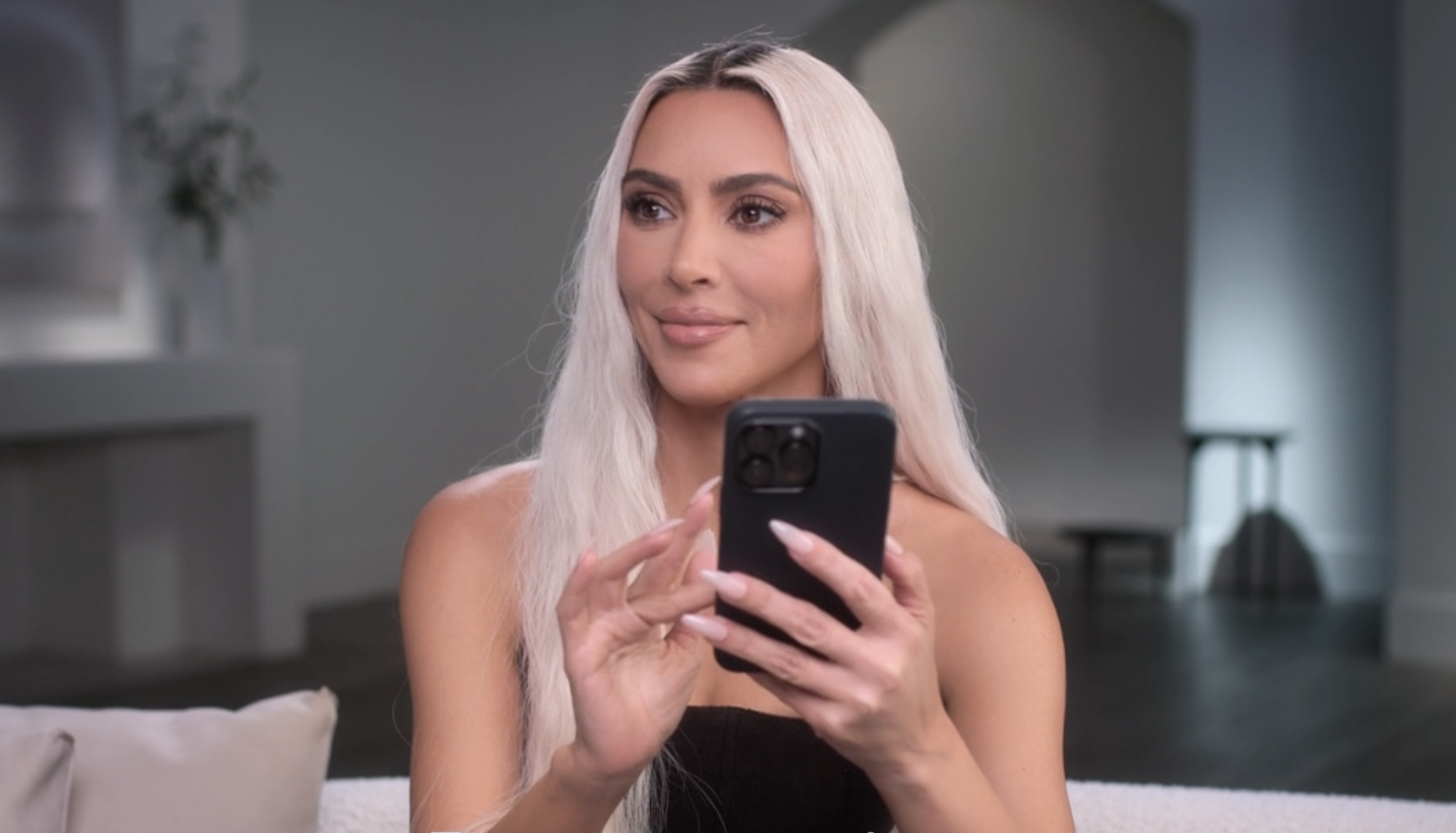 Close-up of Kim holding a cellphone