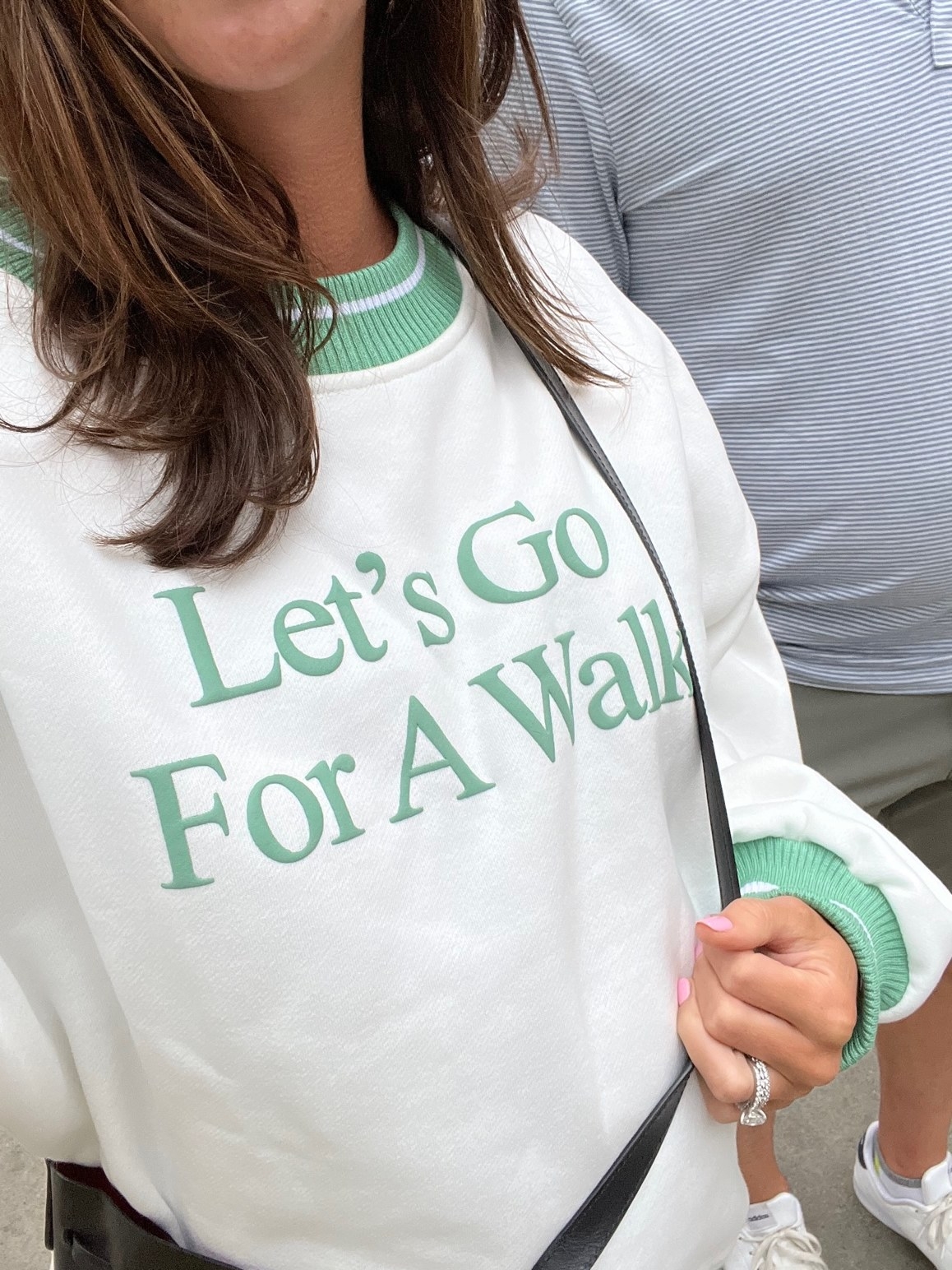 Me wearing a sweatshirt that says &quot;let&#x27;s go for a walk.&quot;