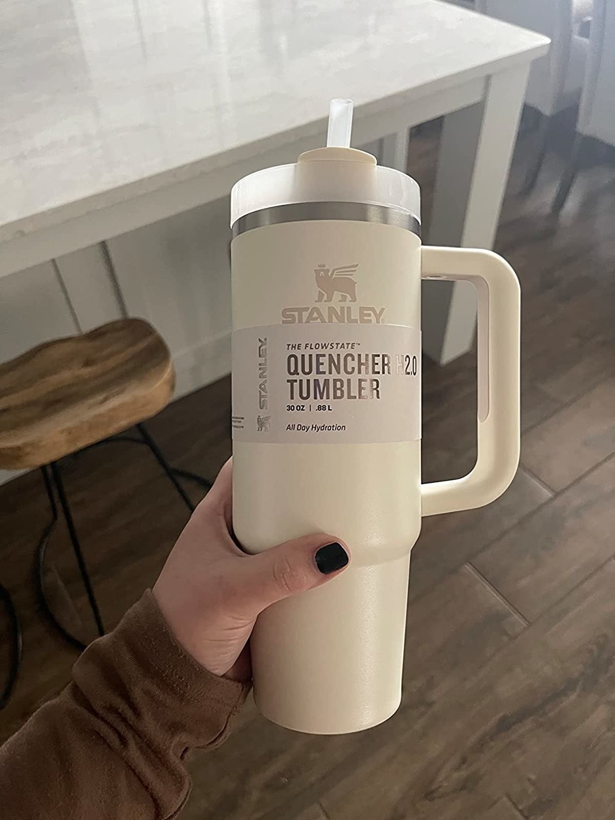 Reviewer holding the white tumbler