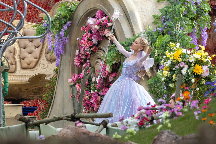 Ariana in a gown as Glinda, surrounded by flowers