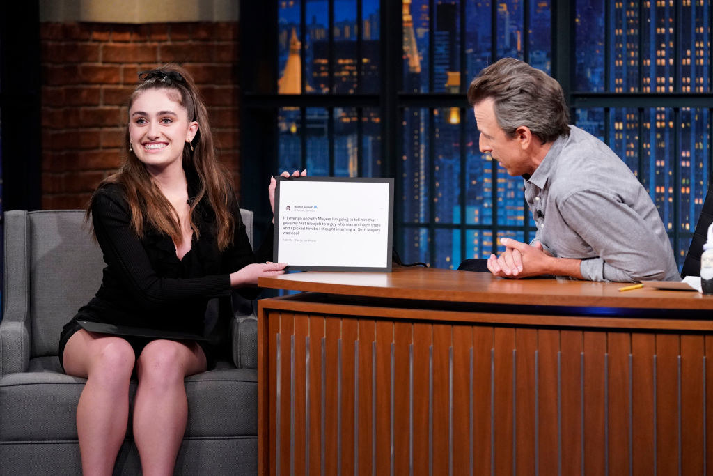 Rachel smiling and holding a framed copy of the tweet on Seth Meyers&#x27; show