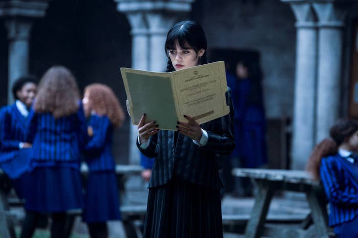 Jenna as Wednesday Addams reading a file