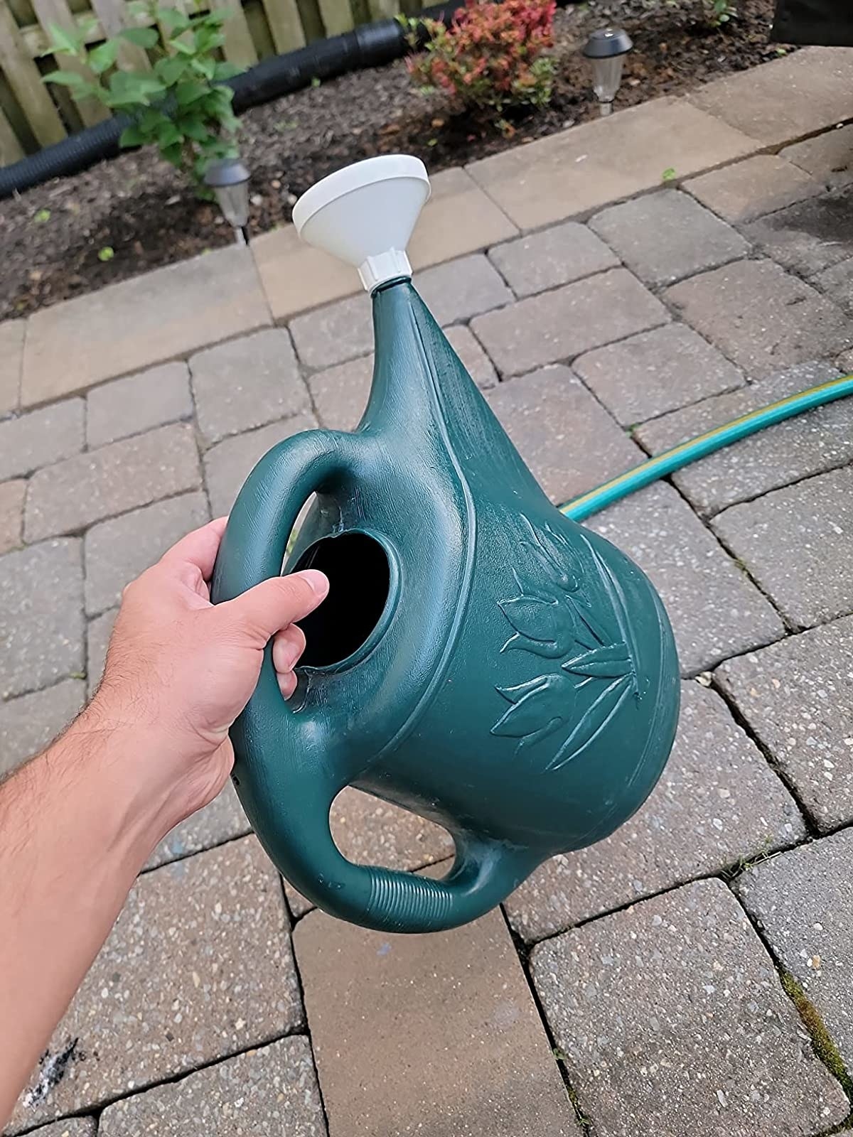 Reviewer&#x27;s photo of them holding the watering can