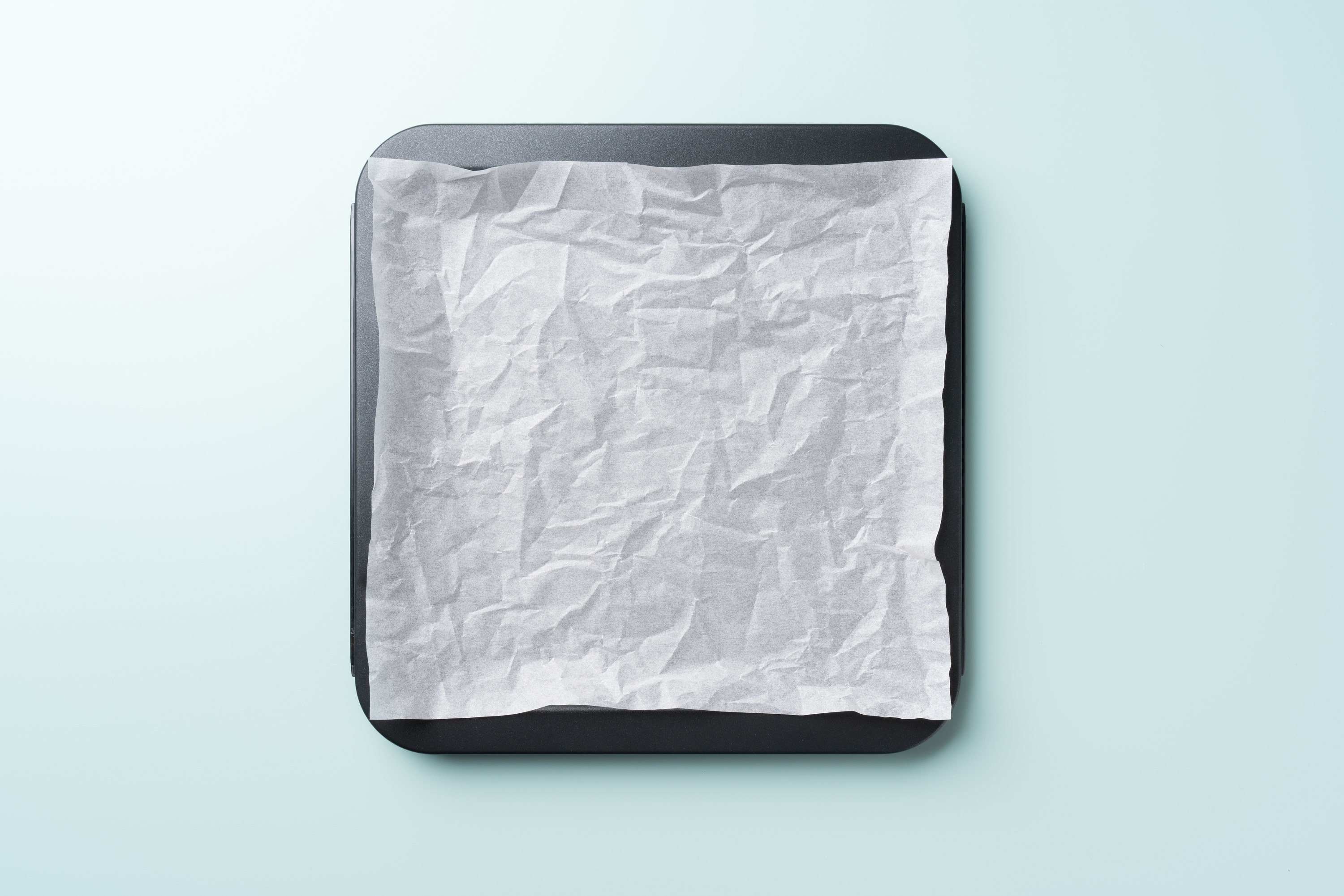 a baking sheet with wax paper on top