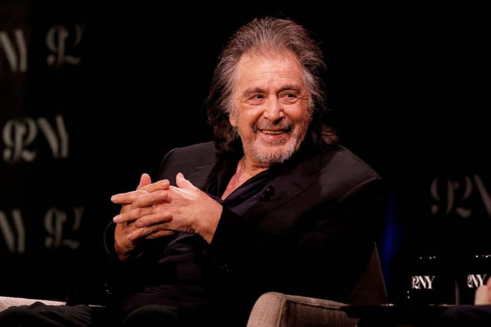 Al Pacino sitting in a chair with his hands crossed