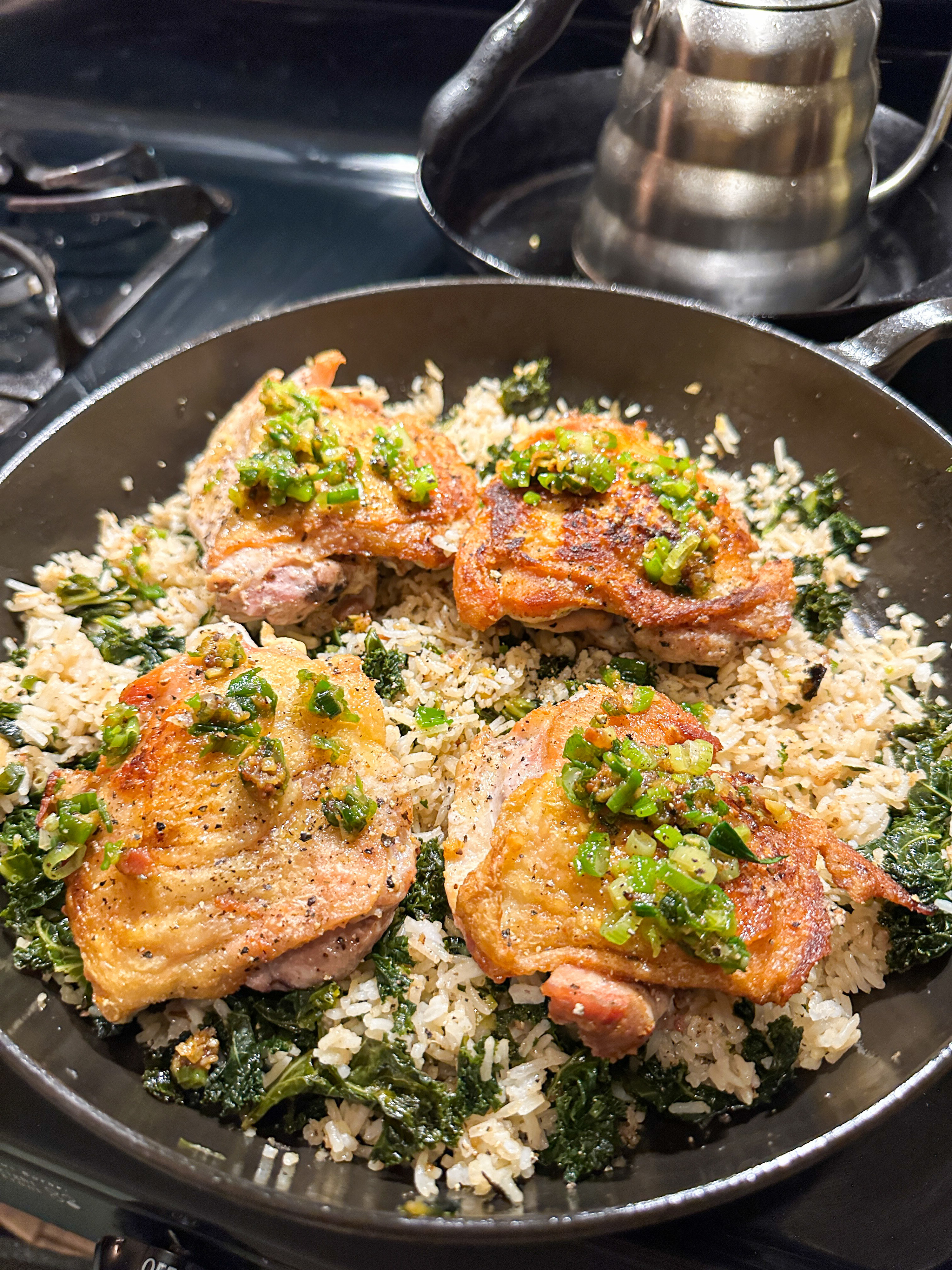 roasted chicken thighs topped with scallion oil and kale rice