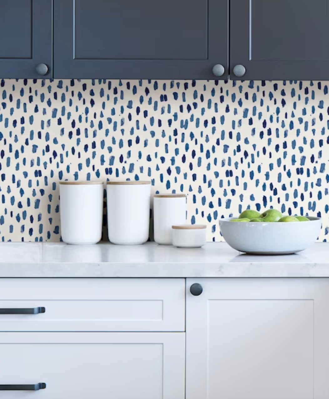 the blue irregular dotted wallpaper on the backsplash of a decorated kitchen