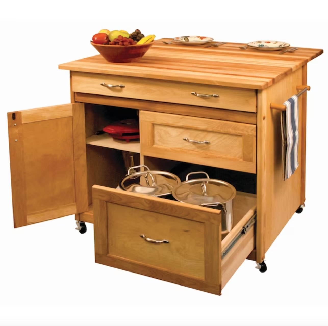 the light wooden kitchen island with several drawers open showing pots and pans