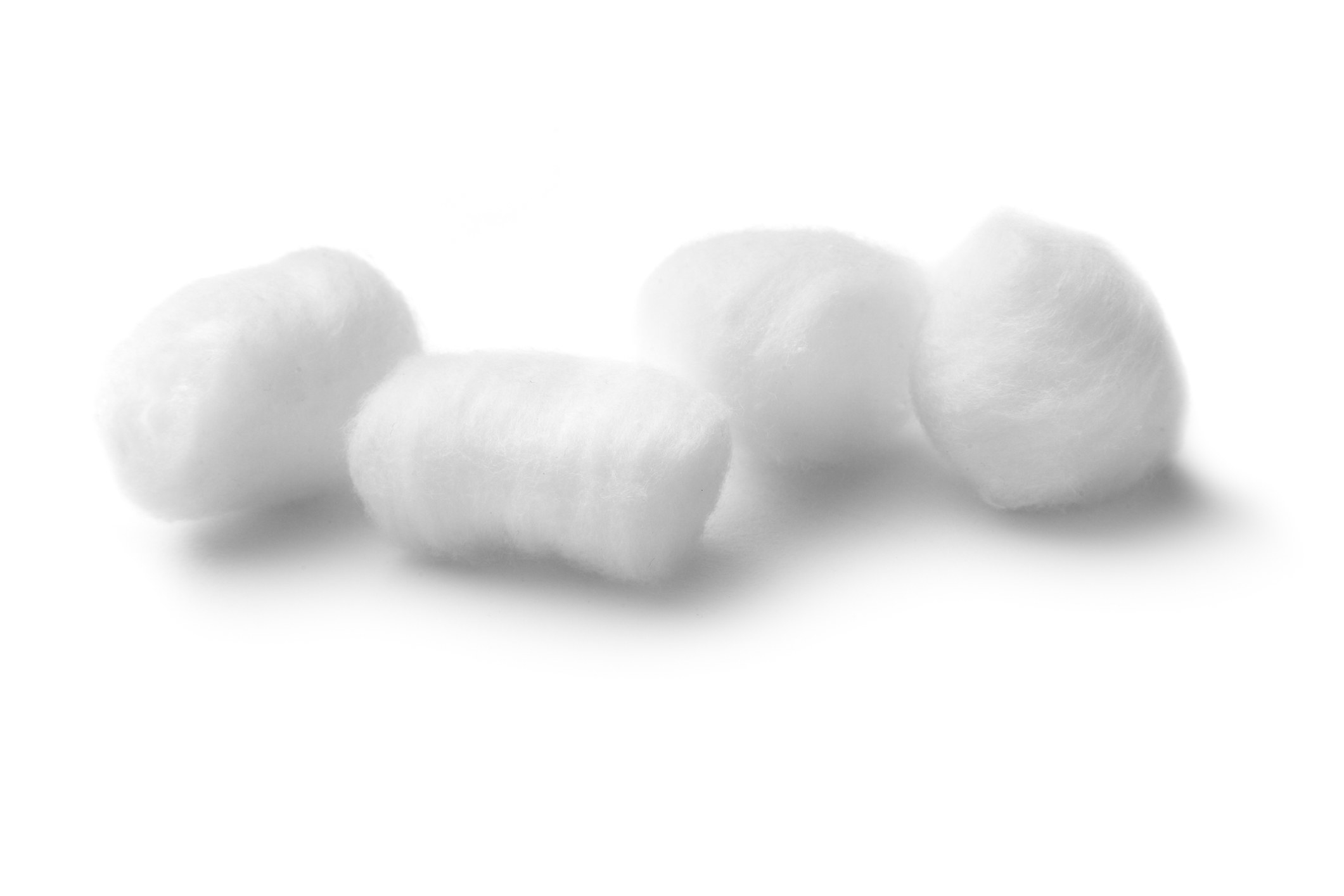 Close-up of four cotton balls