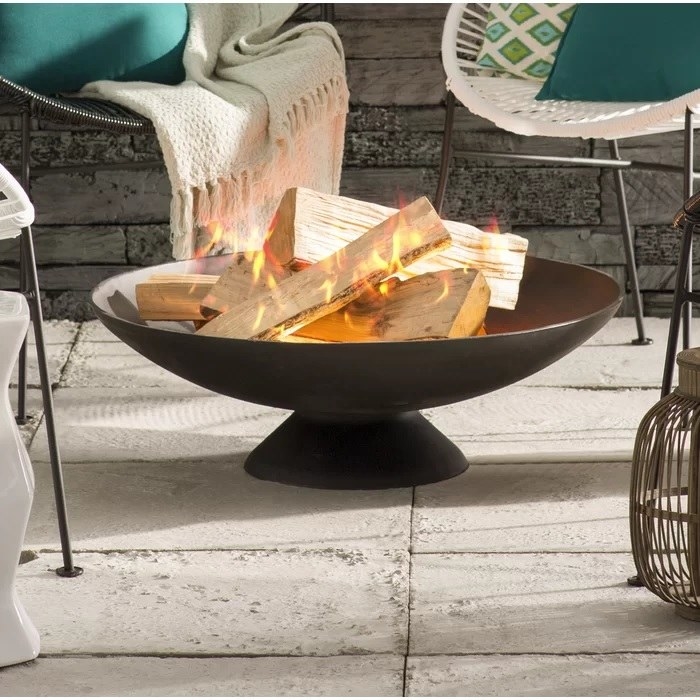 The firepit in the center of a patio set