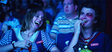 Robin and Steve laughing in a movie theater in &quot;Stranger Things&quot;