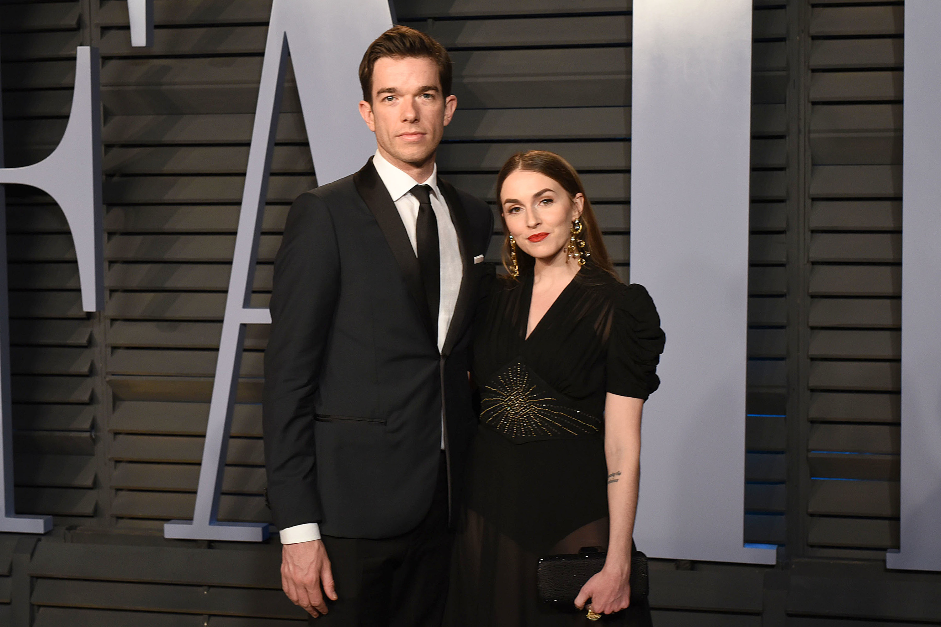 Close-up of John and Anna at a media event