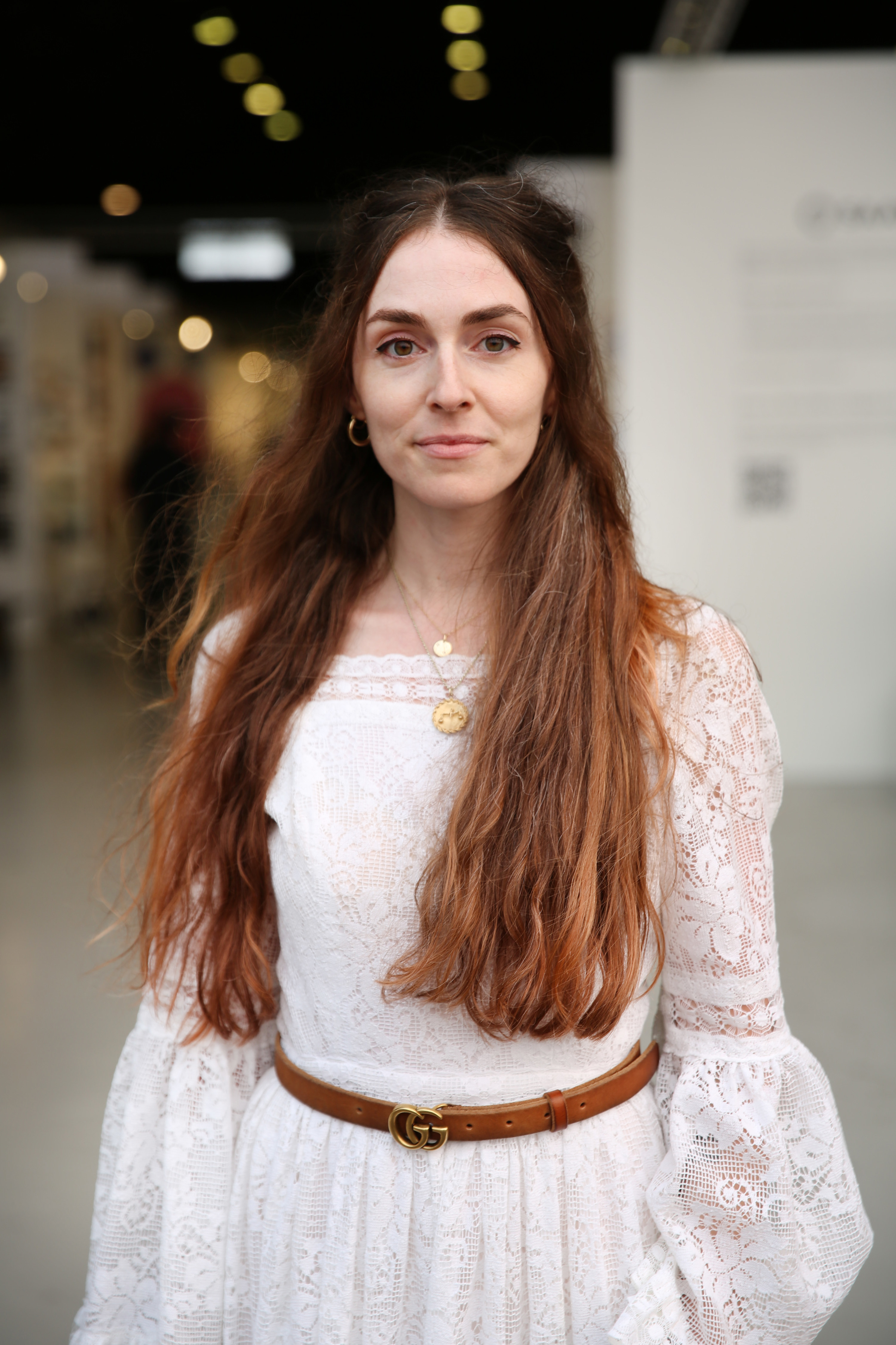 Close-up of Anna in a long-sleeved, lacy dress