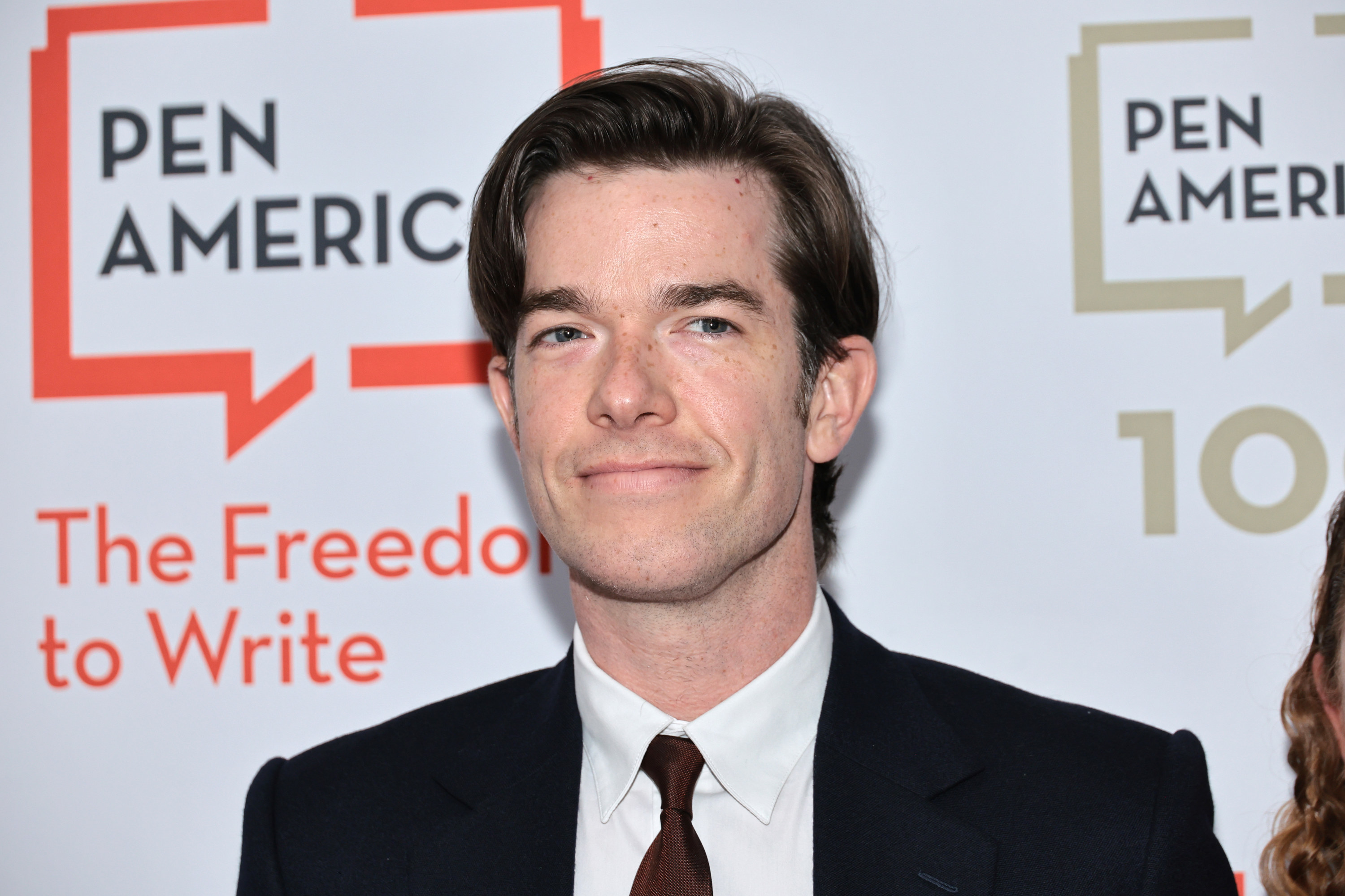 Close-up of John in a suit and tie at a media event