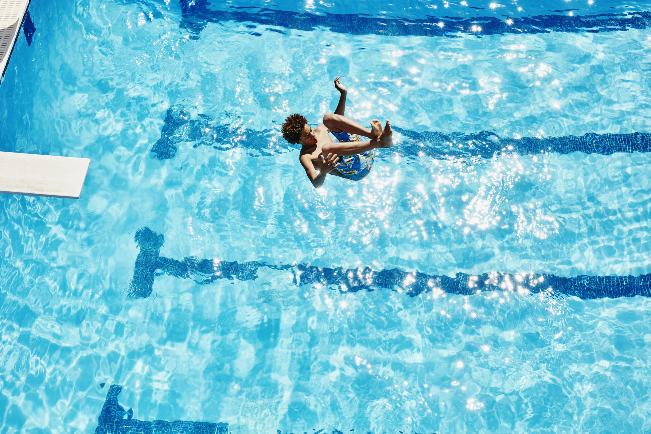 Teenager diving off a diving board