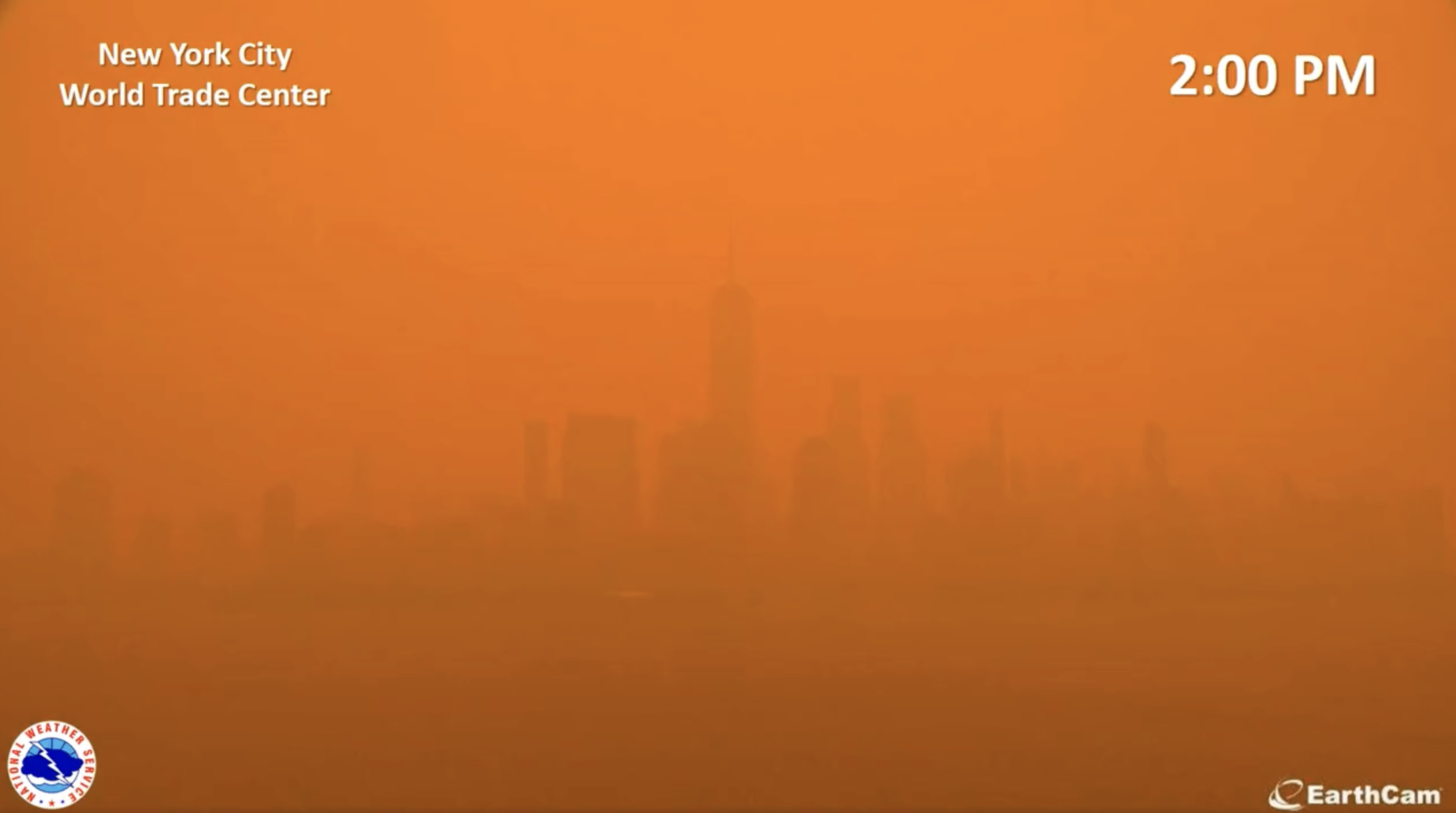 View of the downtown Manhattan skyline at 1:45 pm, with the sky an orange-red