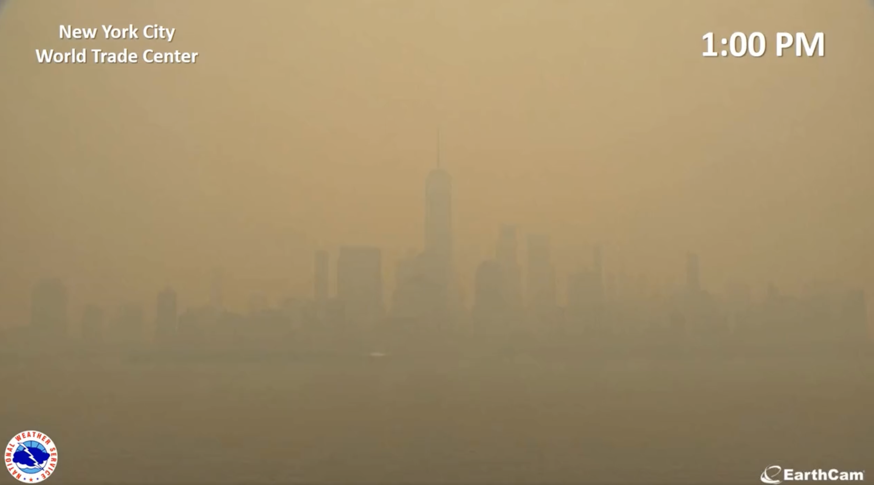 View of the downtown Manhattan skyline at 1 pm, with the sky a deeper orange