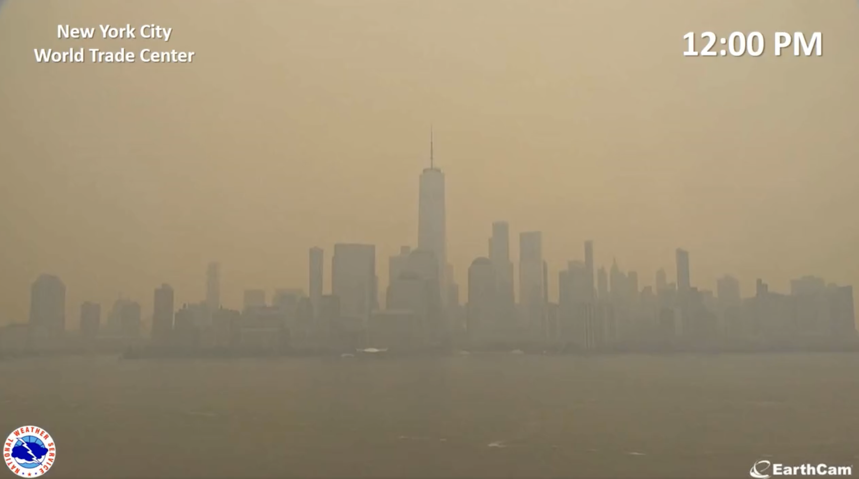 View of the downtown Manhattan skyline at 12 pm, with the sky now a light orange