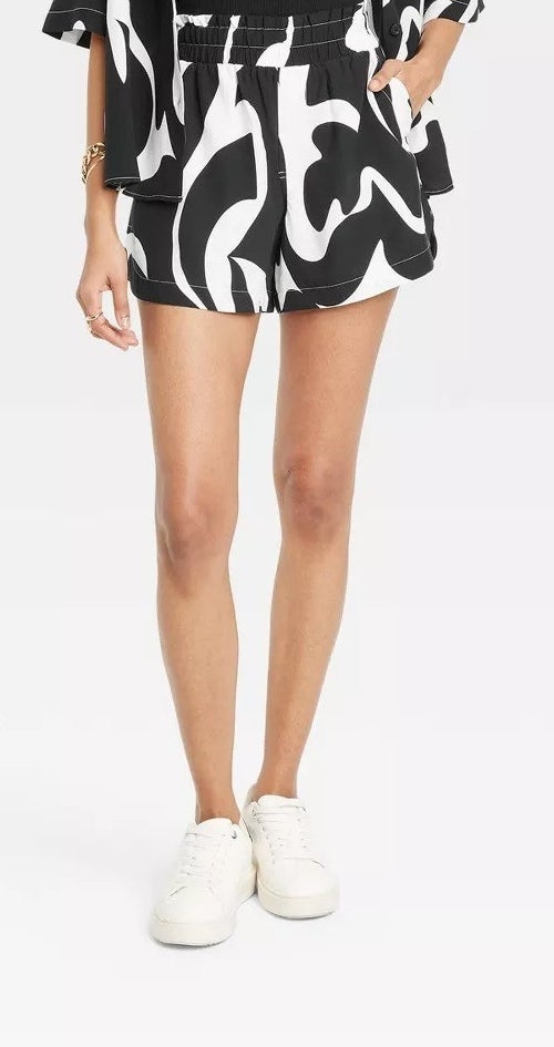 A model wearing the black and white print shorts