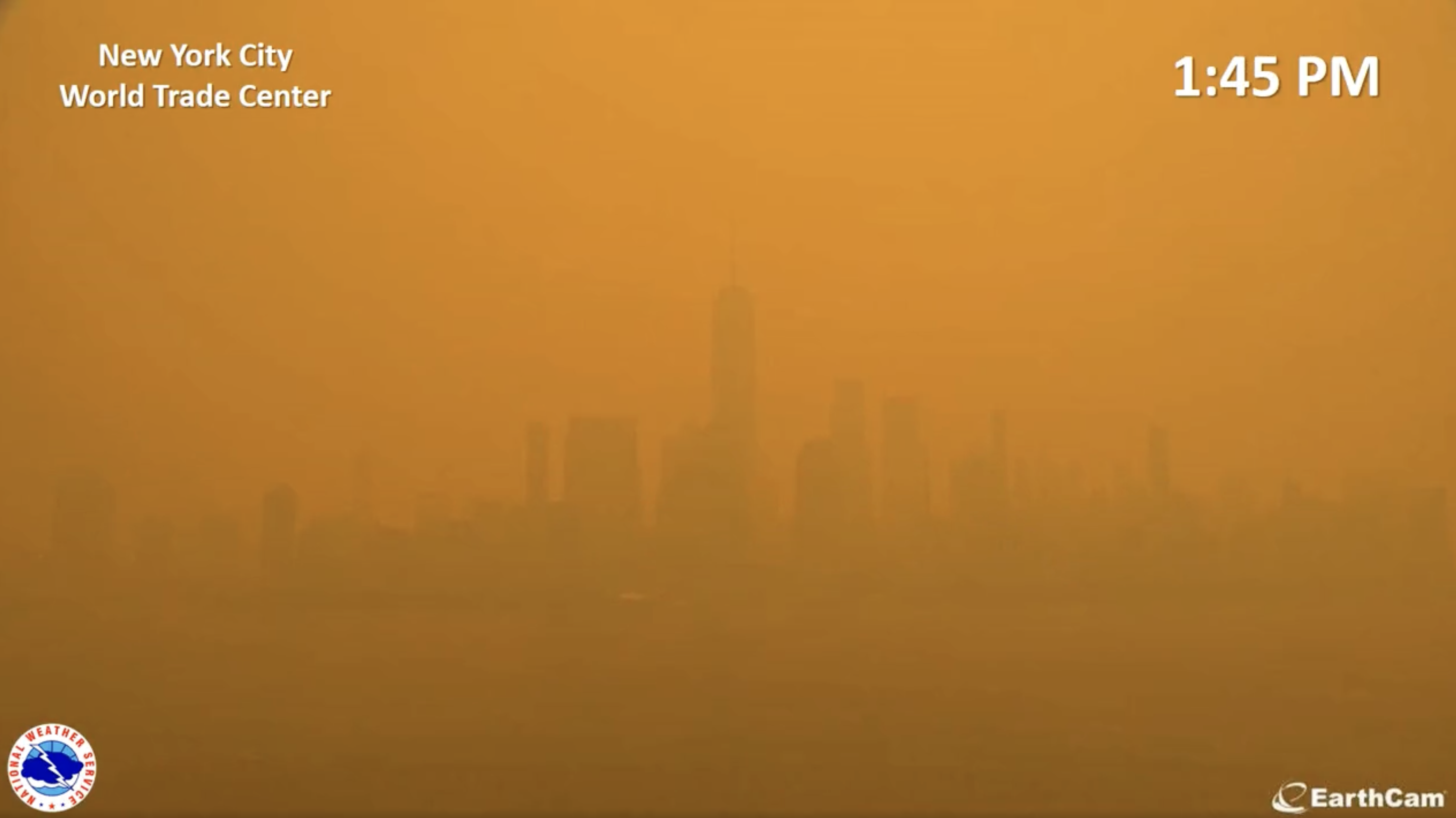 View of the downtown Manhattan skyline at 1:45 pm, with the sky a much deeper orange