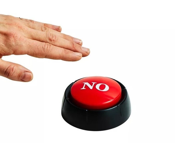 A hand reaching for the red button with the word no on it