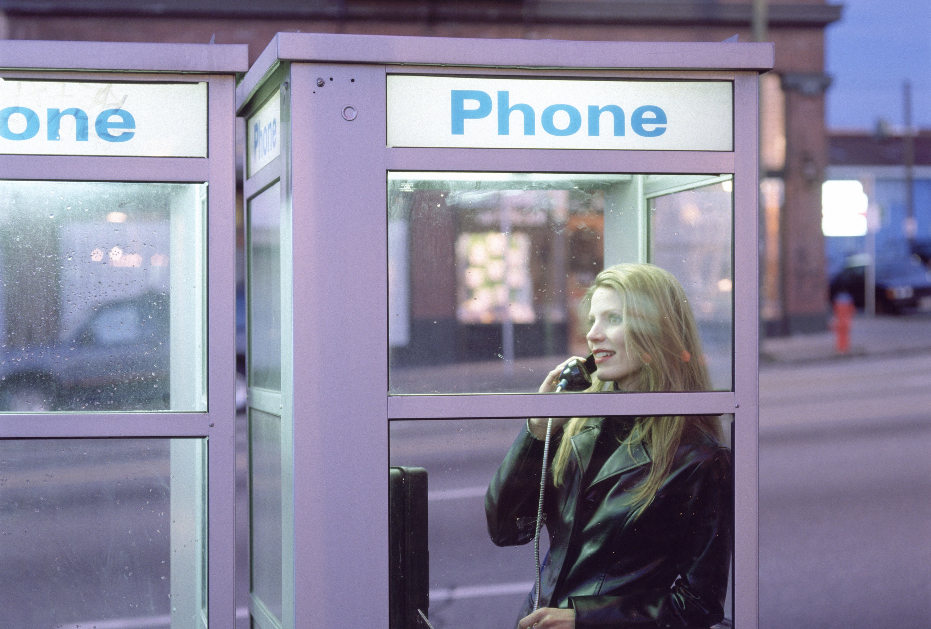 woman in a public telephone booth
