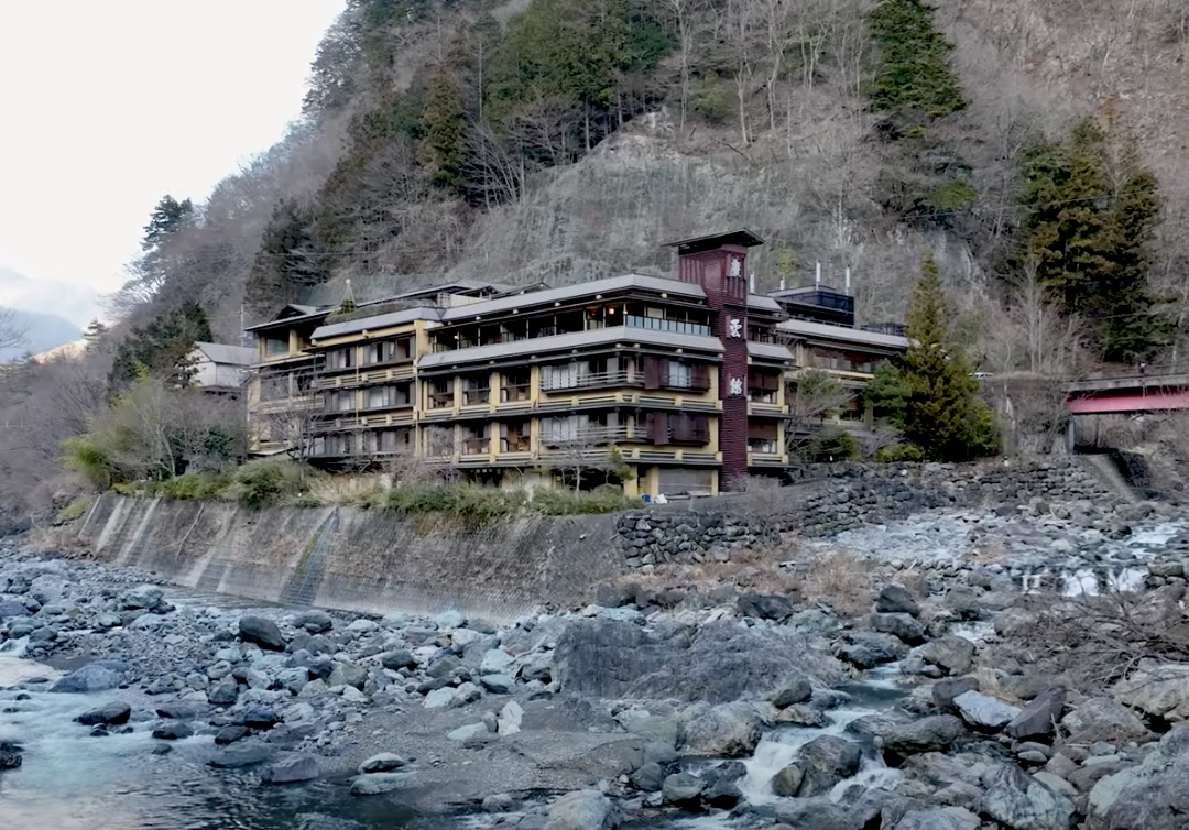 4 storied hotel along the bottom of a mountain