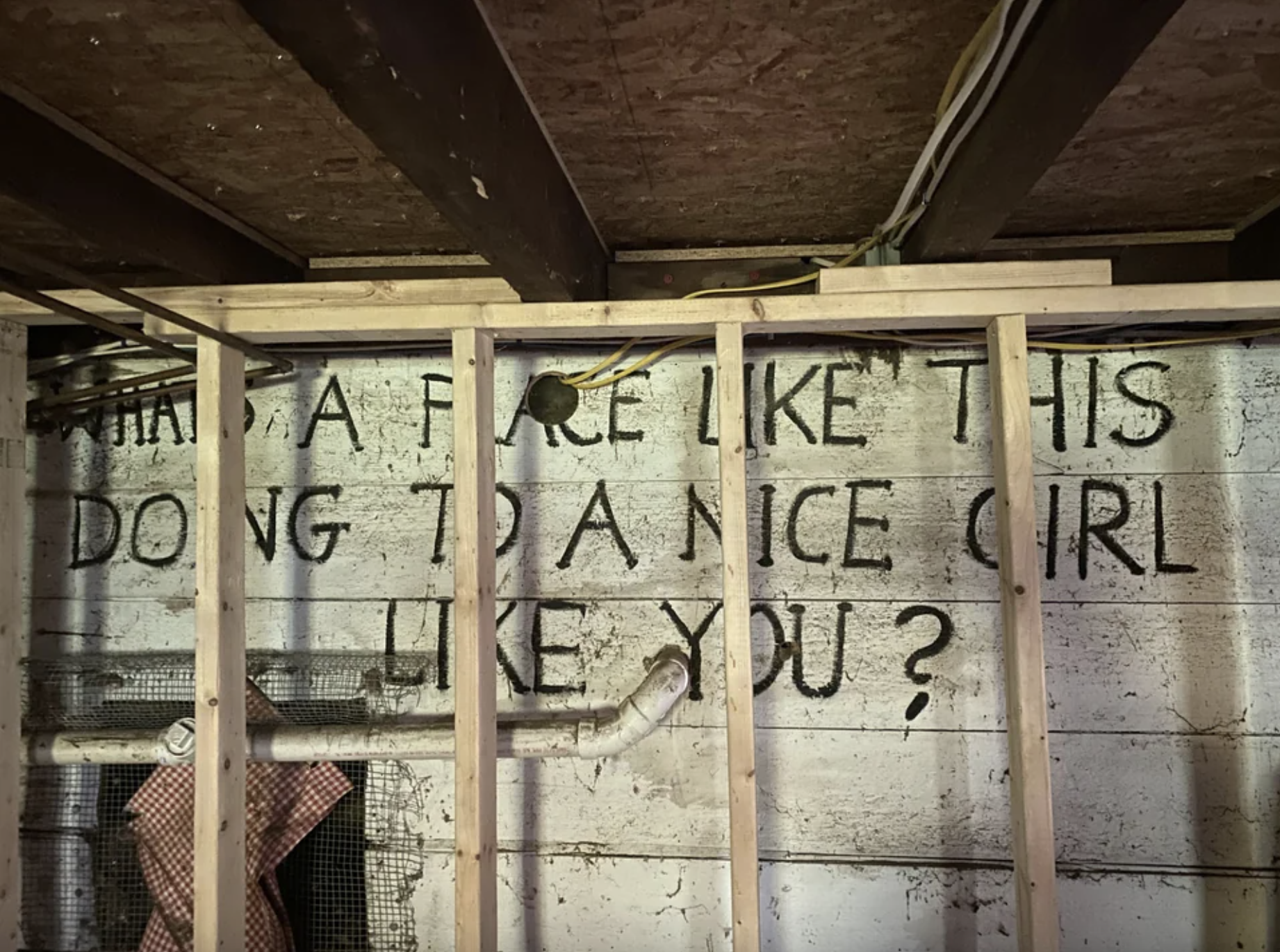 big block letters painted on a basement wall