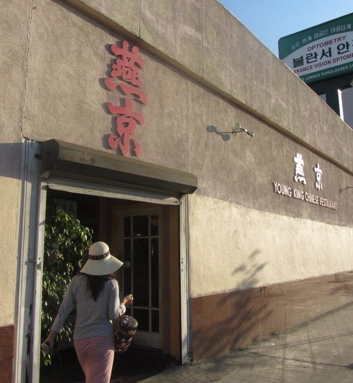 A woman in front of Young King Chinese Restaurant
