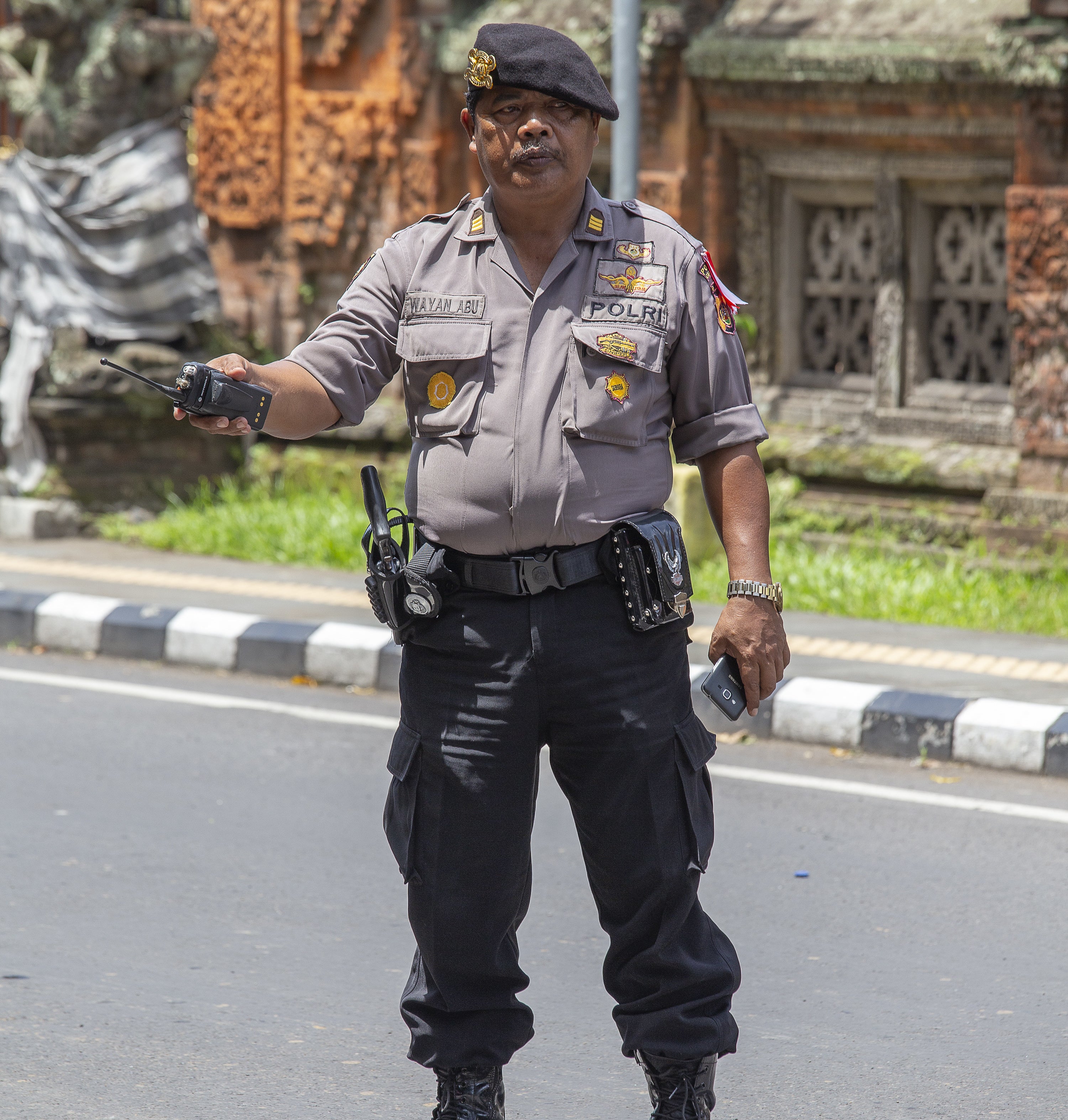 A Balinese police officer standing in the street