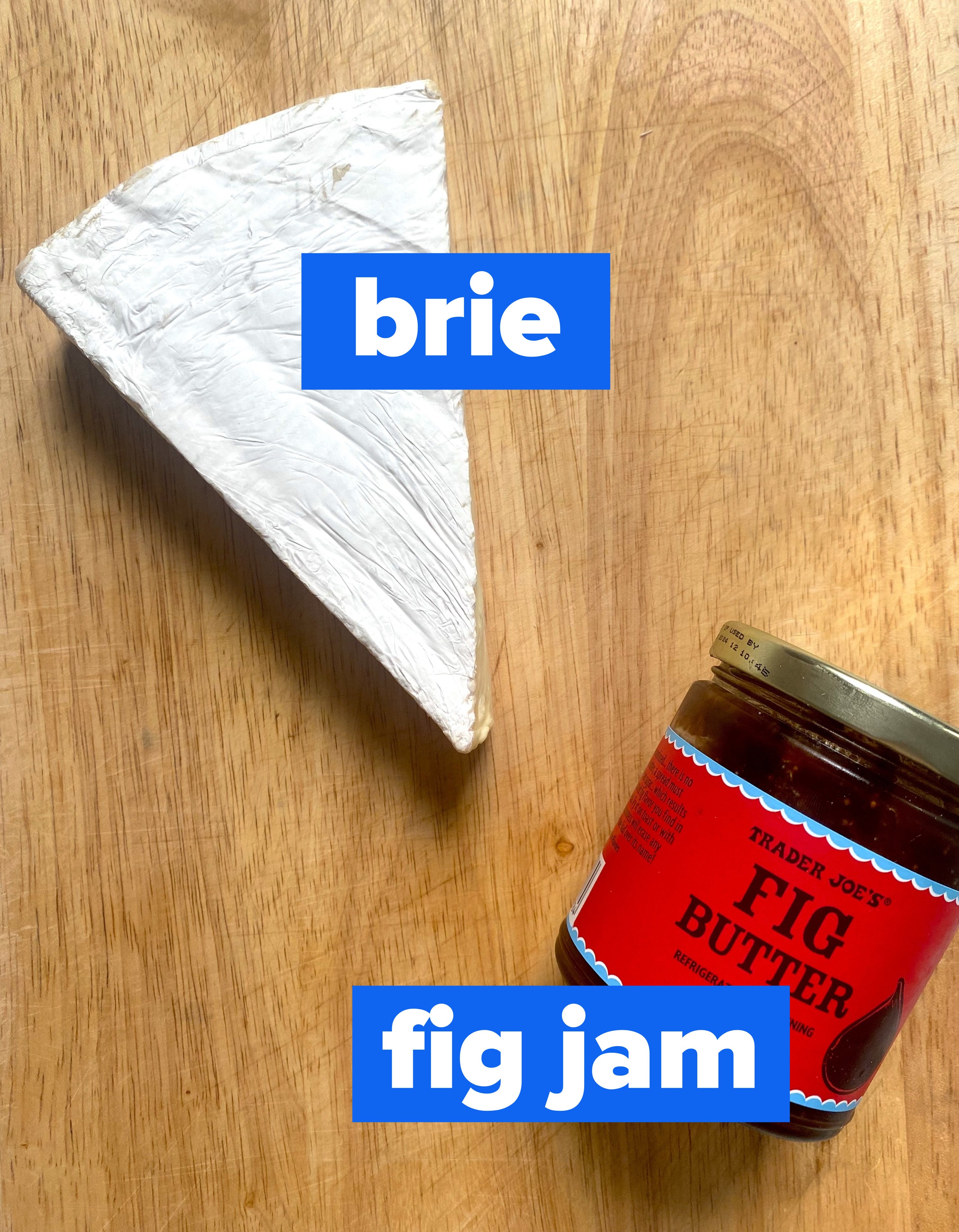Brie and a jar of fig jam on a cutting board