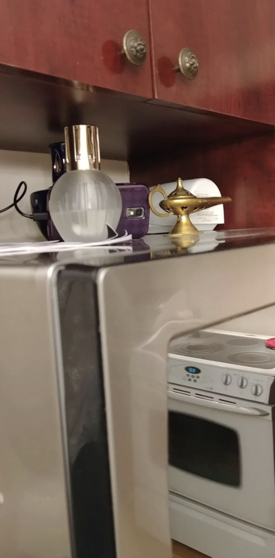 Close-up of a camera on top of a kitchen appliance, below a cabinet