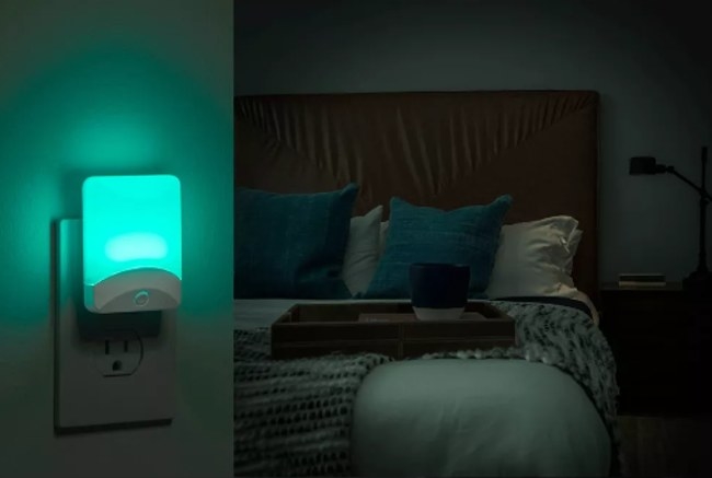 Illuminated colorful night-light plugged into wall outlet