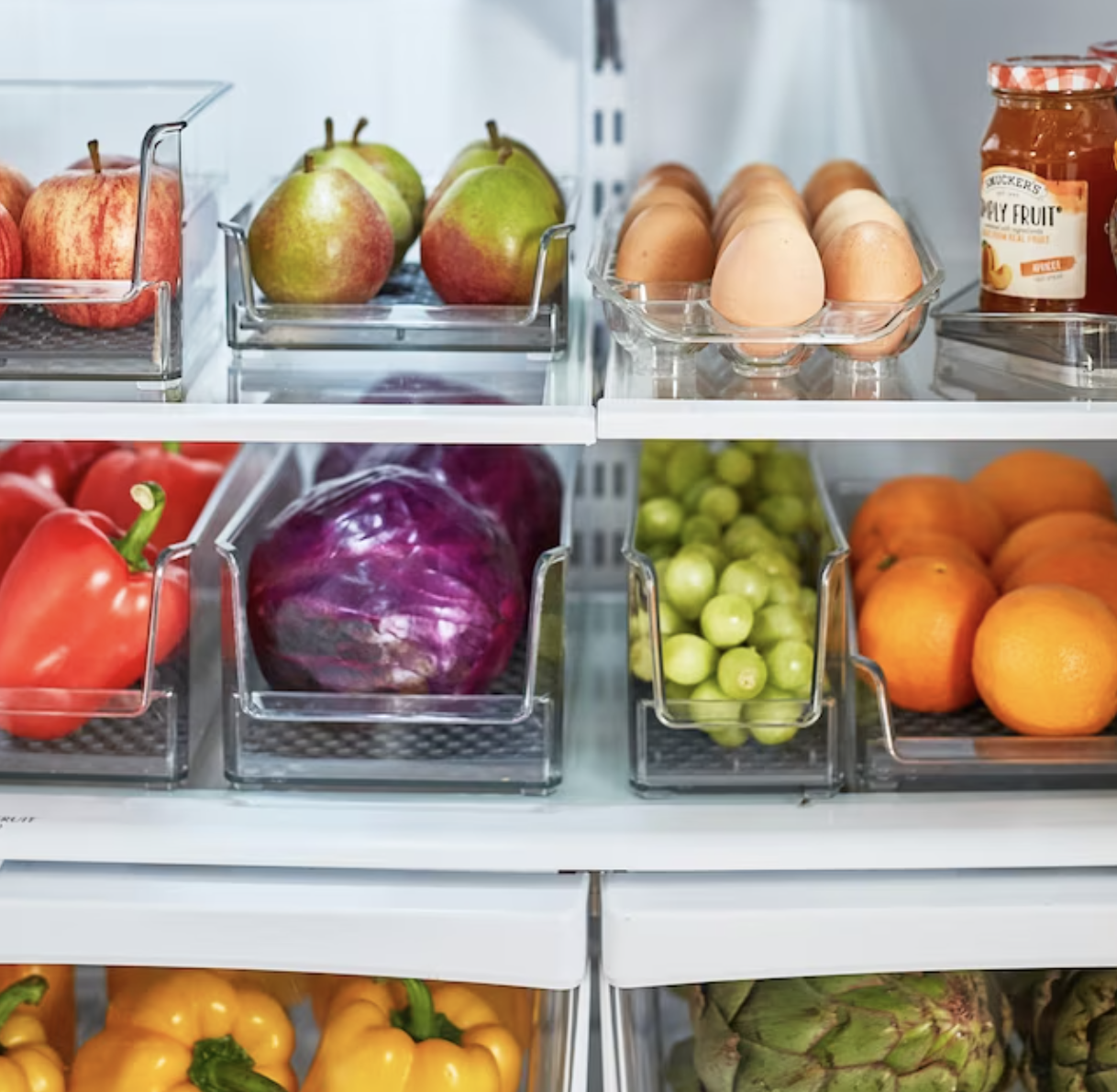 clear fridge bins with fruits and veggies on fridge shelves