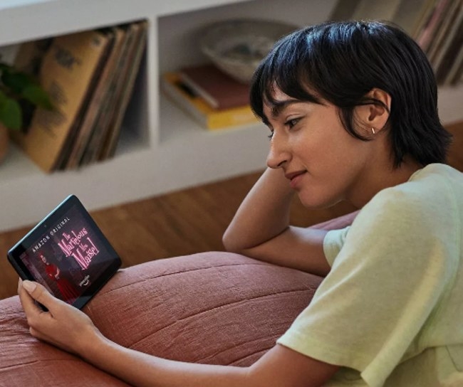 A child watching The Marvelous Mrs. Maisel on a small black tablet