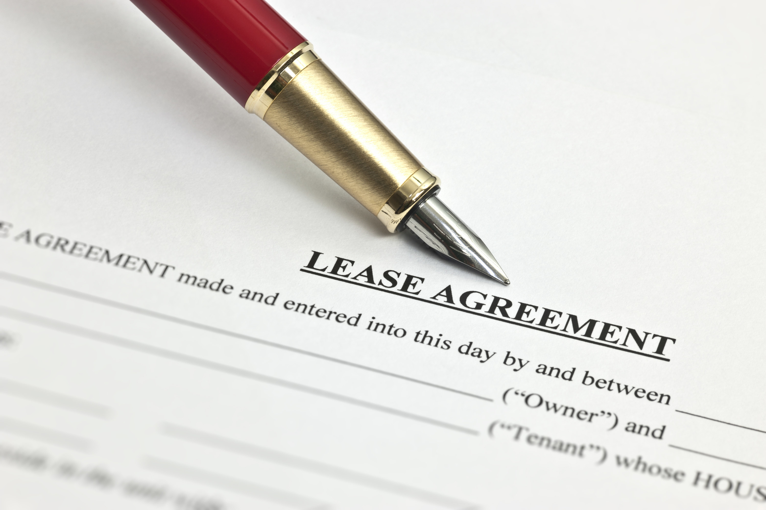 a lease agreement paper with a pen