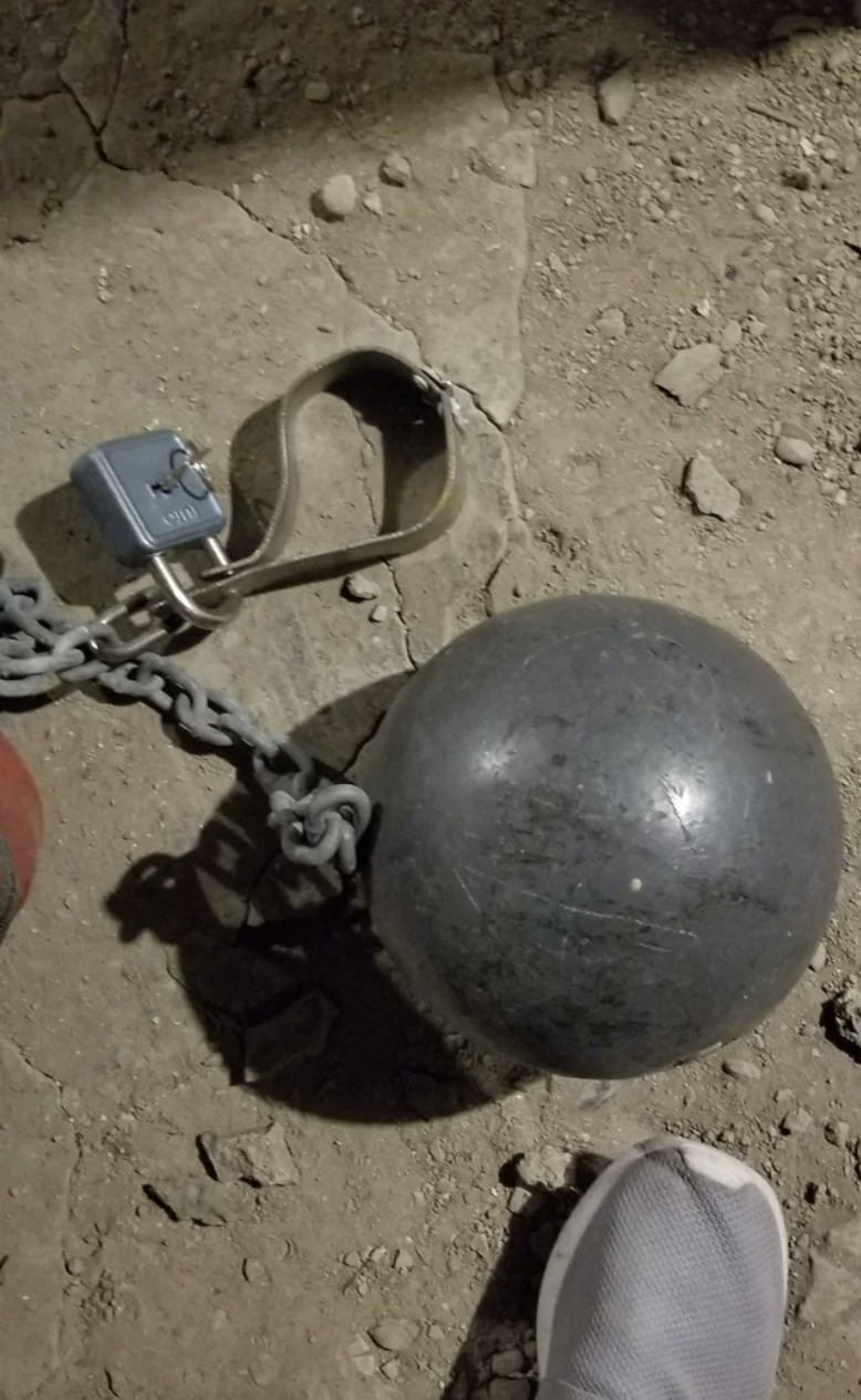 ankle shackle with a heavy ball attached