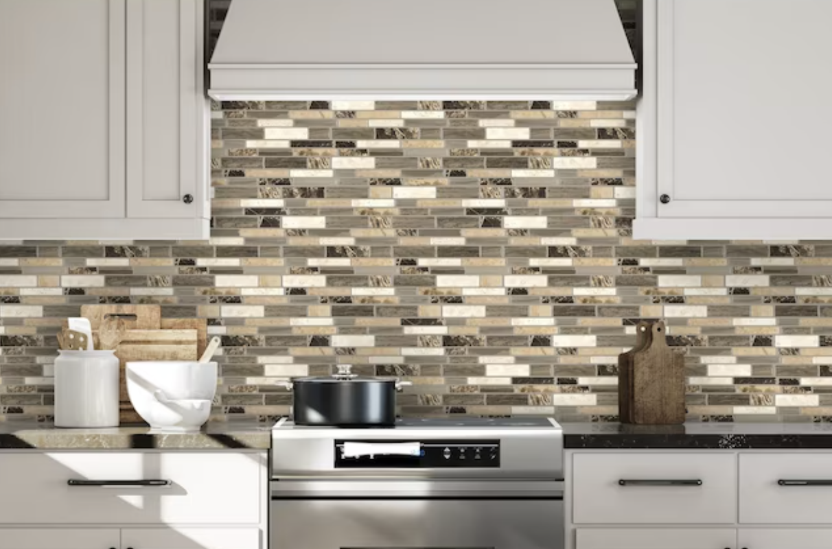 the black, brown, and white peel-and-stick mosaic backsplash behind a stove