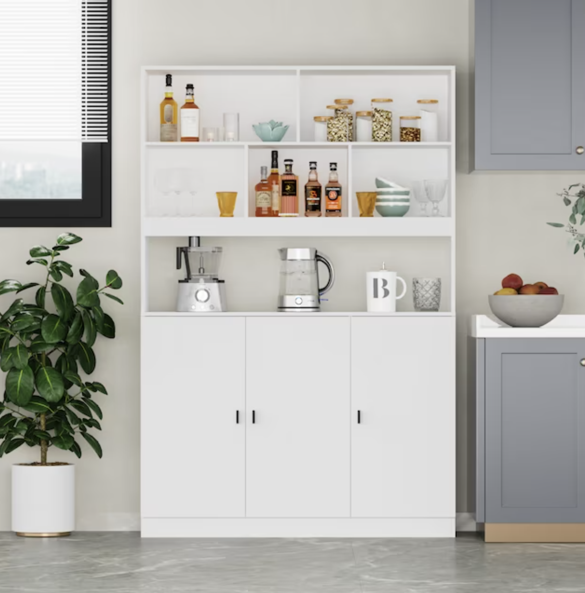 the freestanding white pantry with shelves of appliances and wine bottles