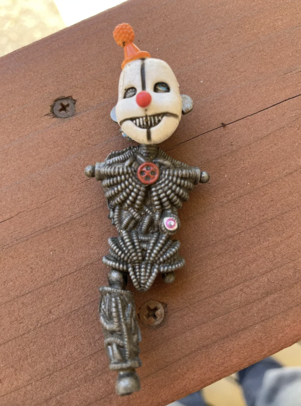 creepy clown doll missing an arm and leg
