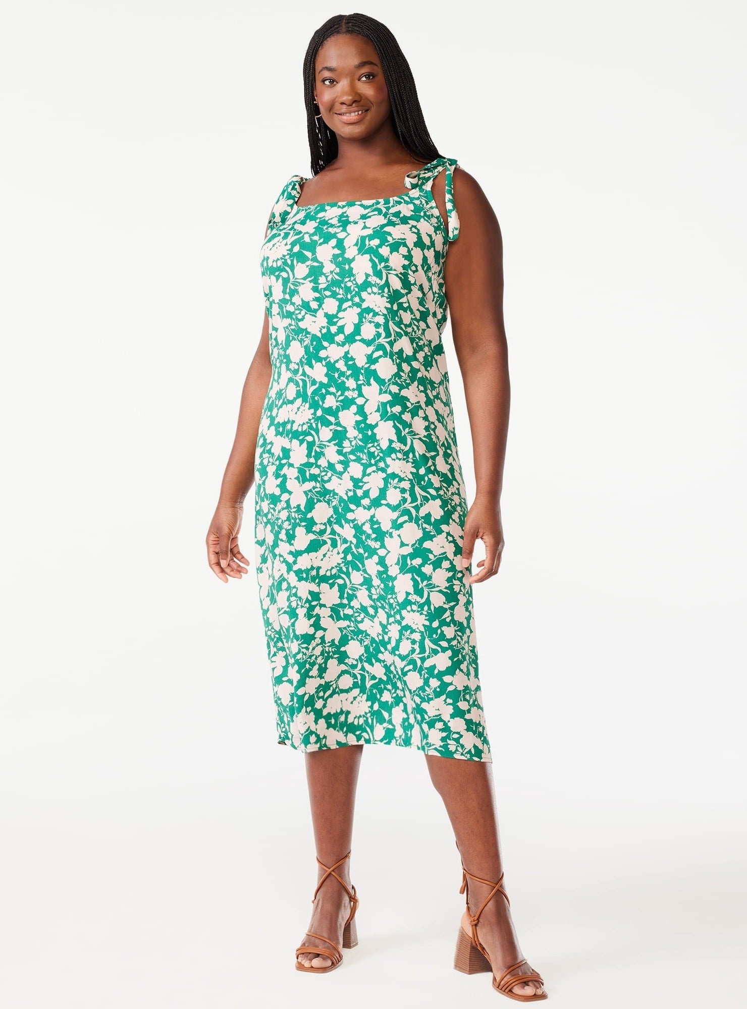 A model in the green and white floral midi