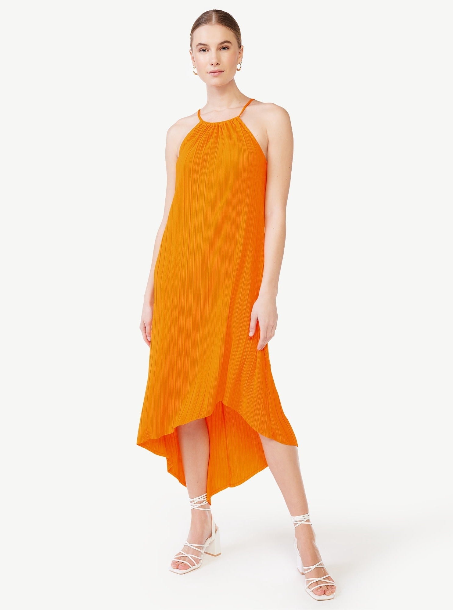 A model in the orange micro pleated frock