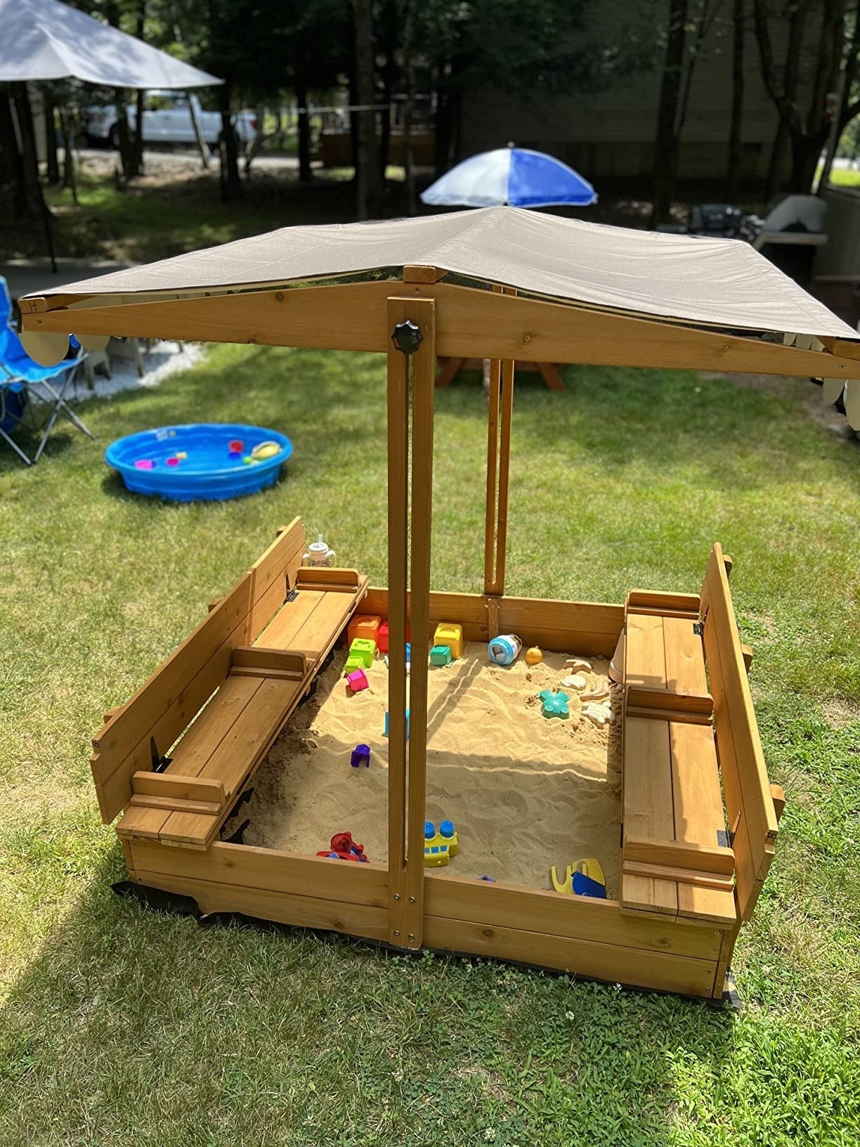 a reviewer photo of the sandbox setup in a backyard