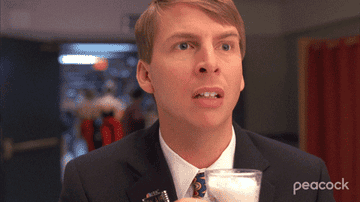 A man looking surprised and then chugging glass of coffee