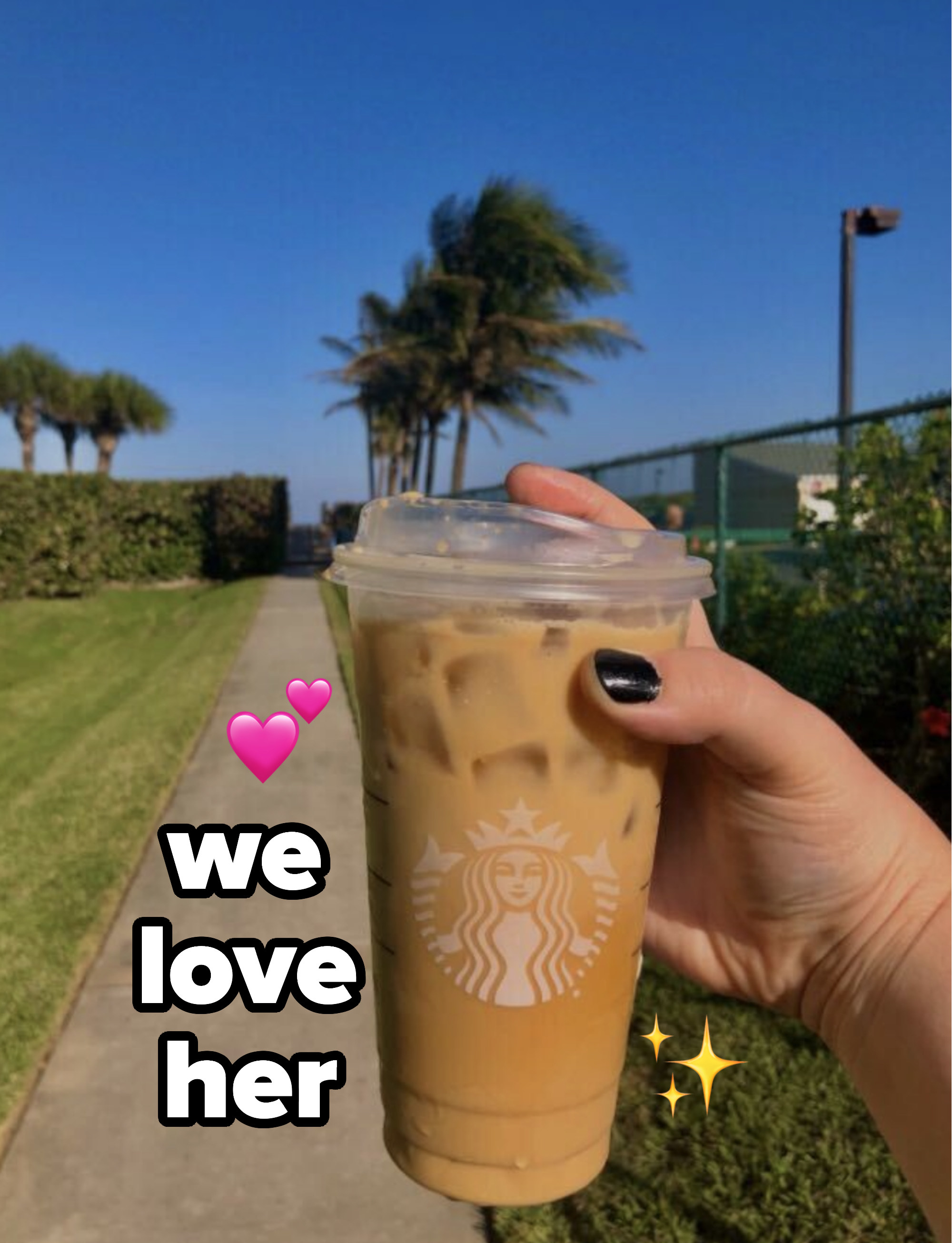 Kelsie's hand holding an iced coffee with text beside it that says "we love her"
