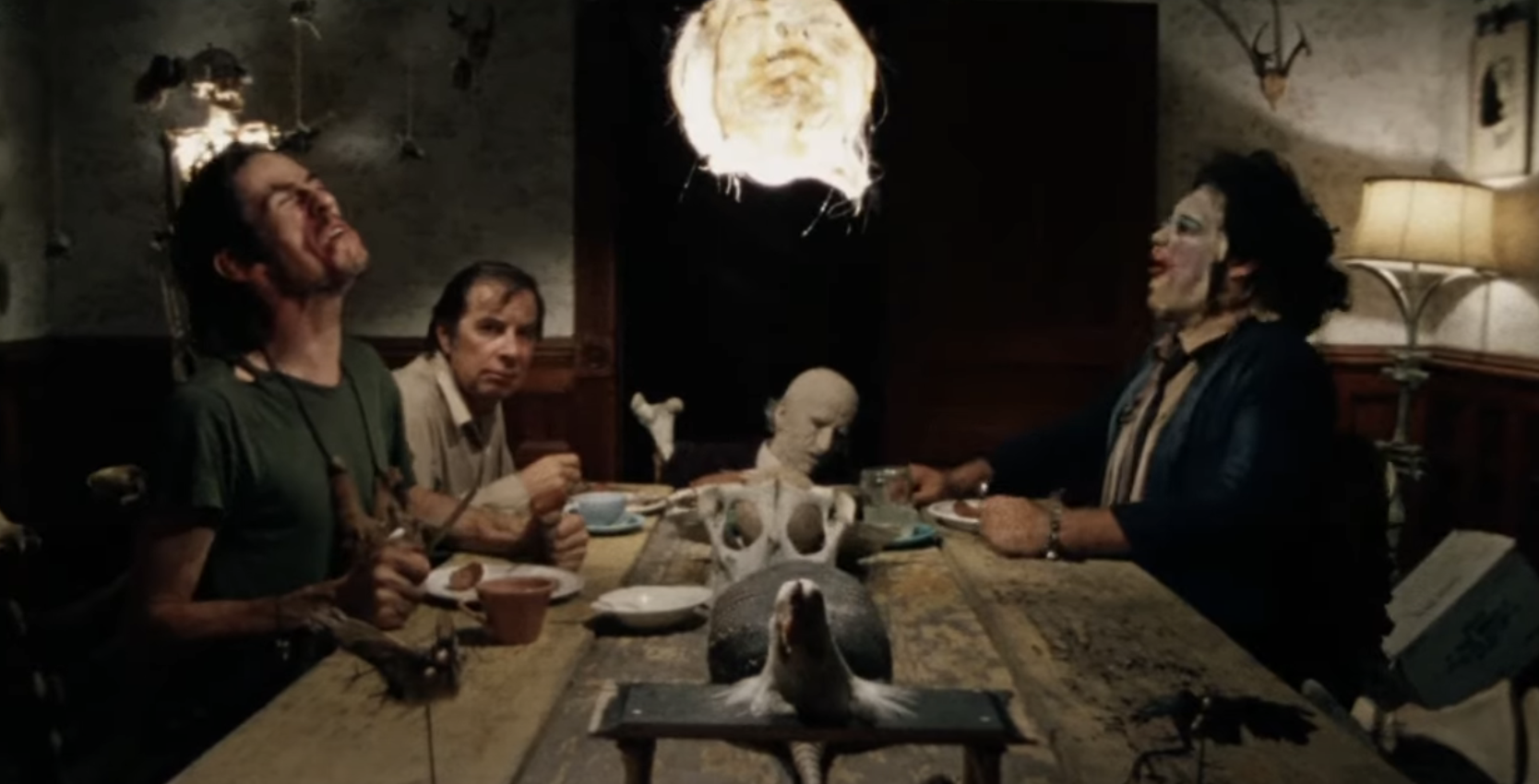 A scene from the movie around the family dinner table, with a skull in the middle