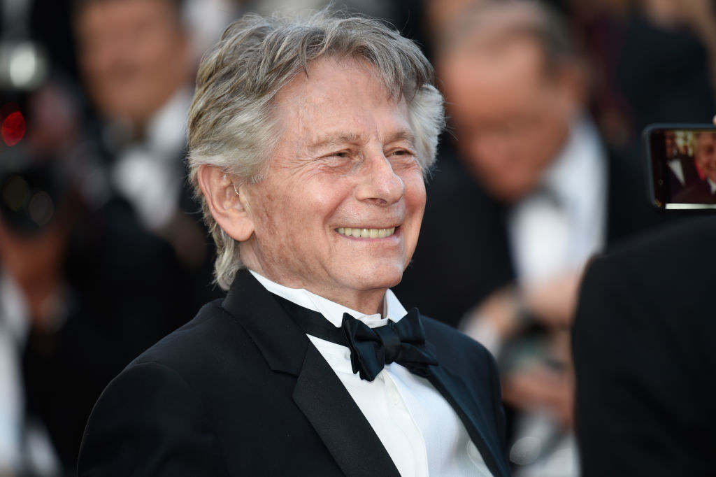 Close-up of Polanski in a bow tie smiling
