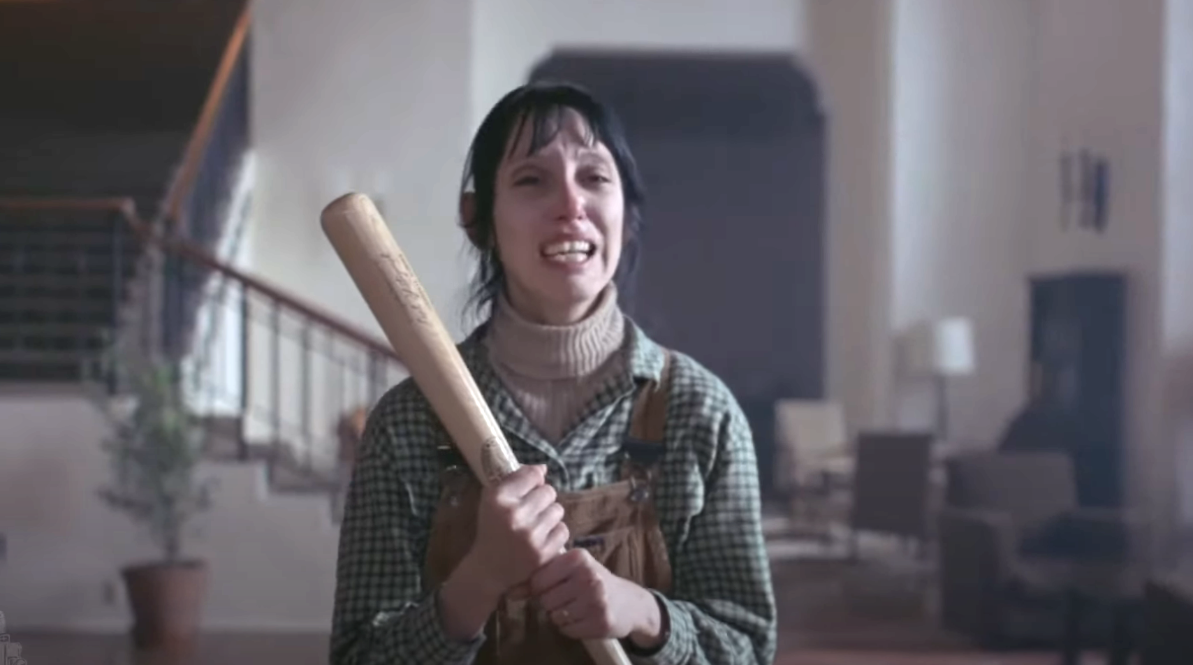Shelley holding a baseball bat and looking distraught