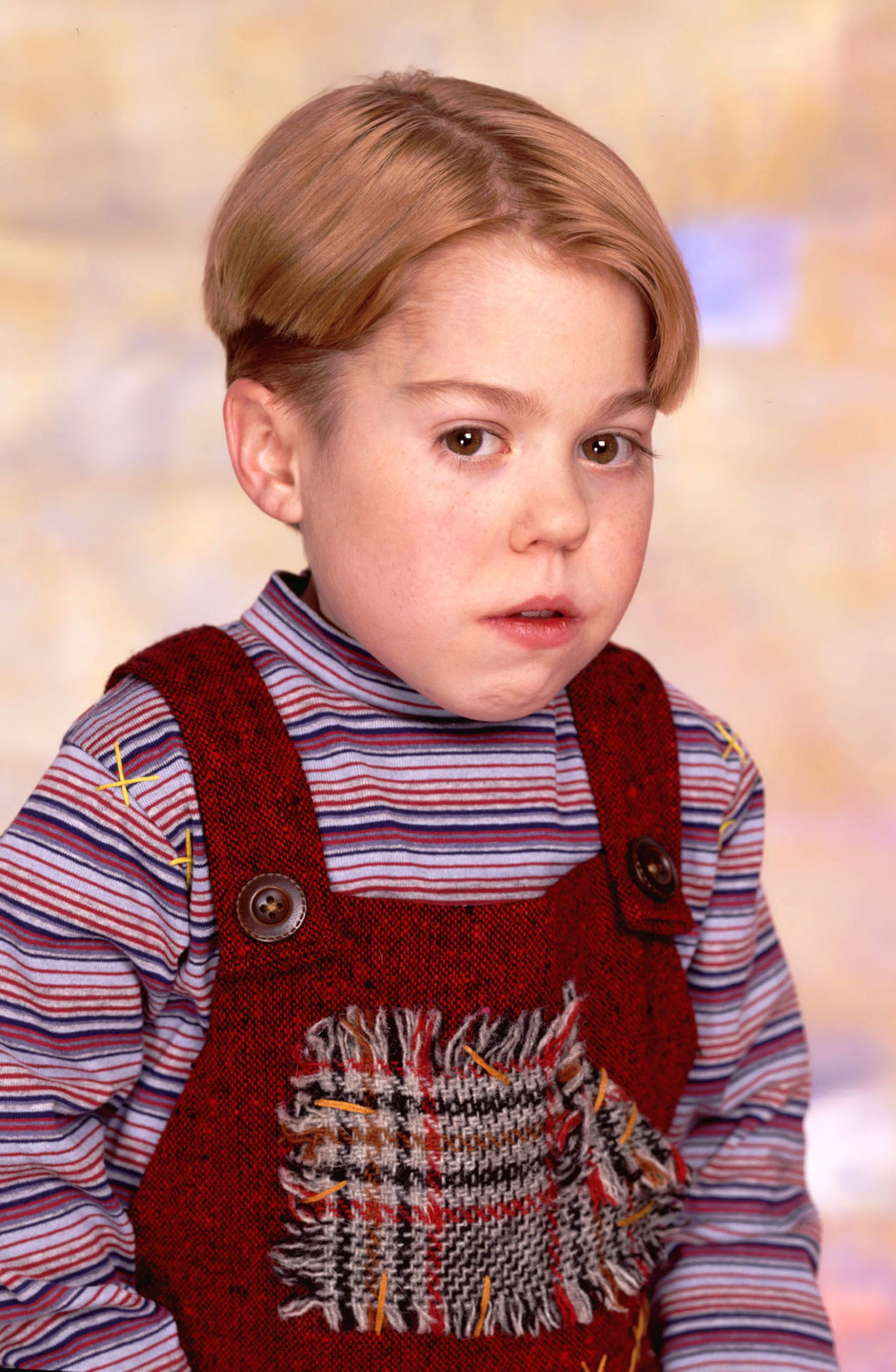Close-up of Evans in overalls and a striped shirt